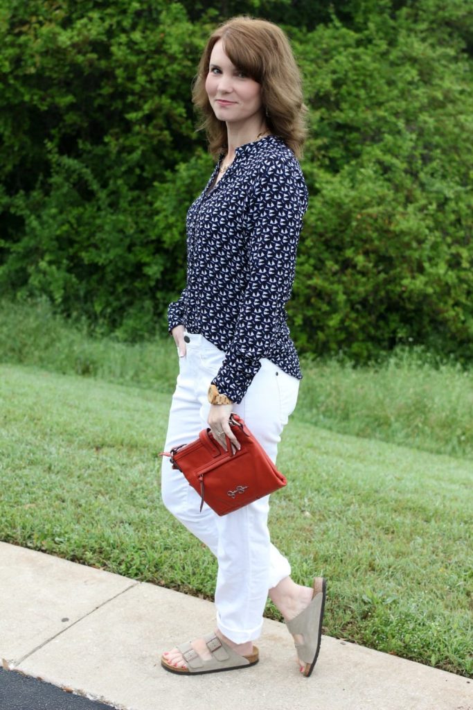 Spring fashion: White boyfriend jeans, Birkenstocks, button up shirt, orange handbag.