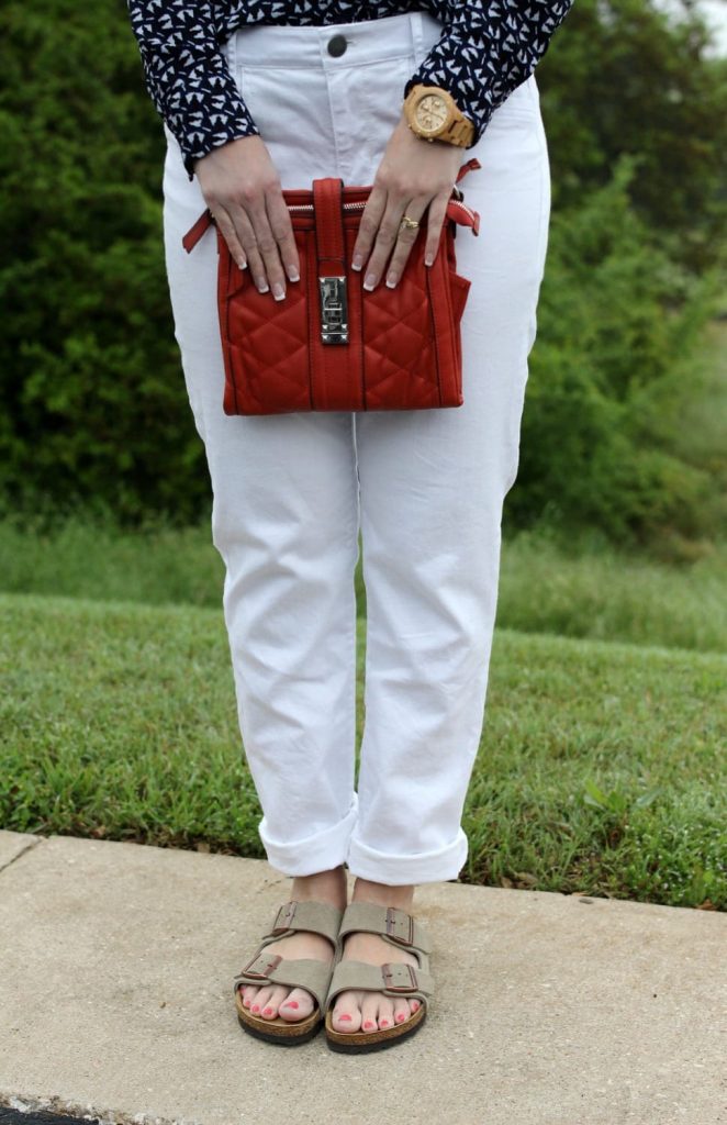 Spring fashion: White boyfriend jeans, Birkenstocks, button up shirt, orange handbag.