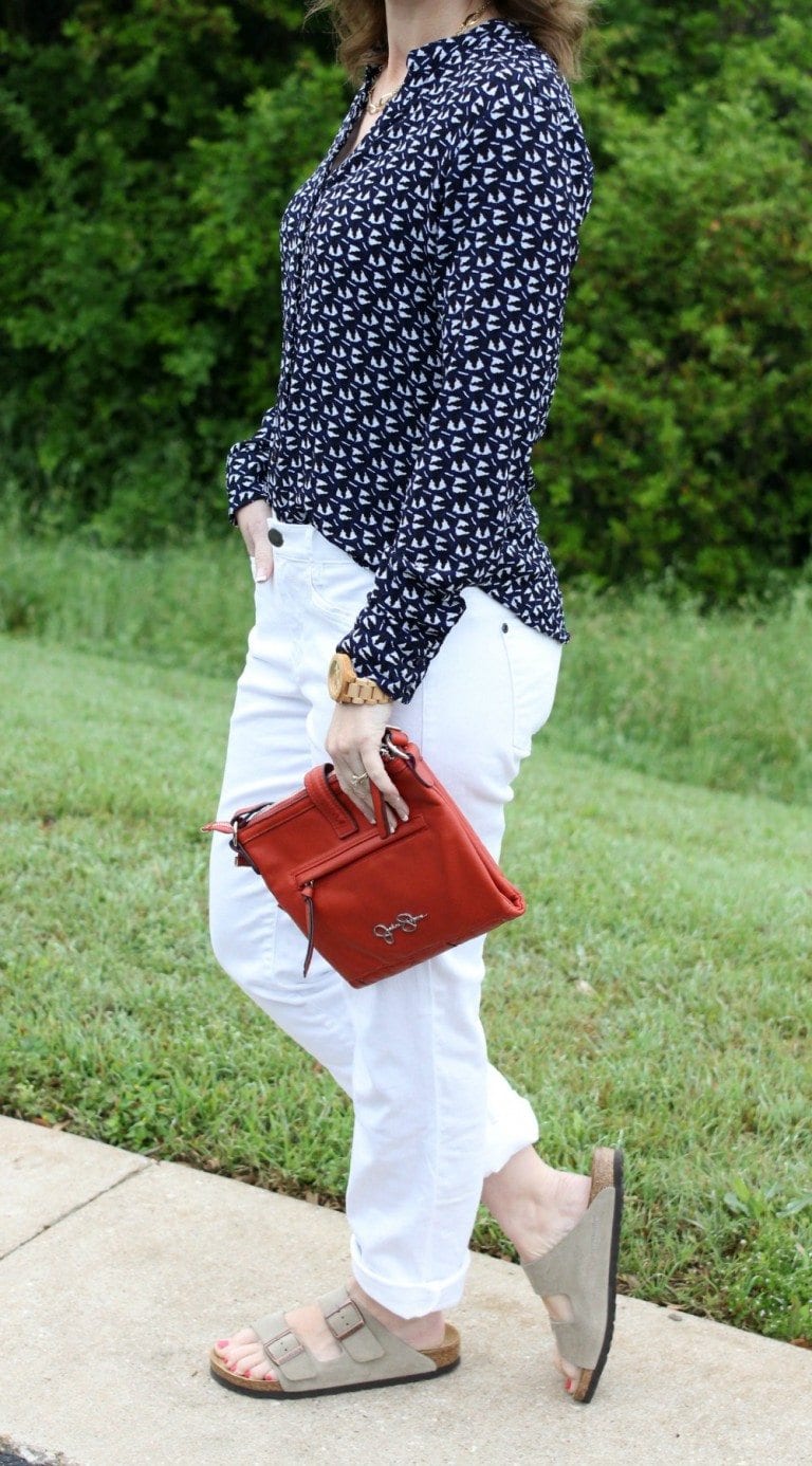Spring fashion: White boyfriend jeans, Birkenstocks, button up shirt, orange handbag.