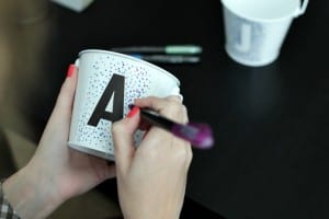 To get the same look, place a large sticker on the surface and begin making dots on the edge of your sticker. I chose three different colors to work with and concentrated on making the dots heavy closer to the sticker’s edge.