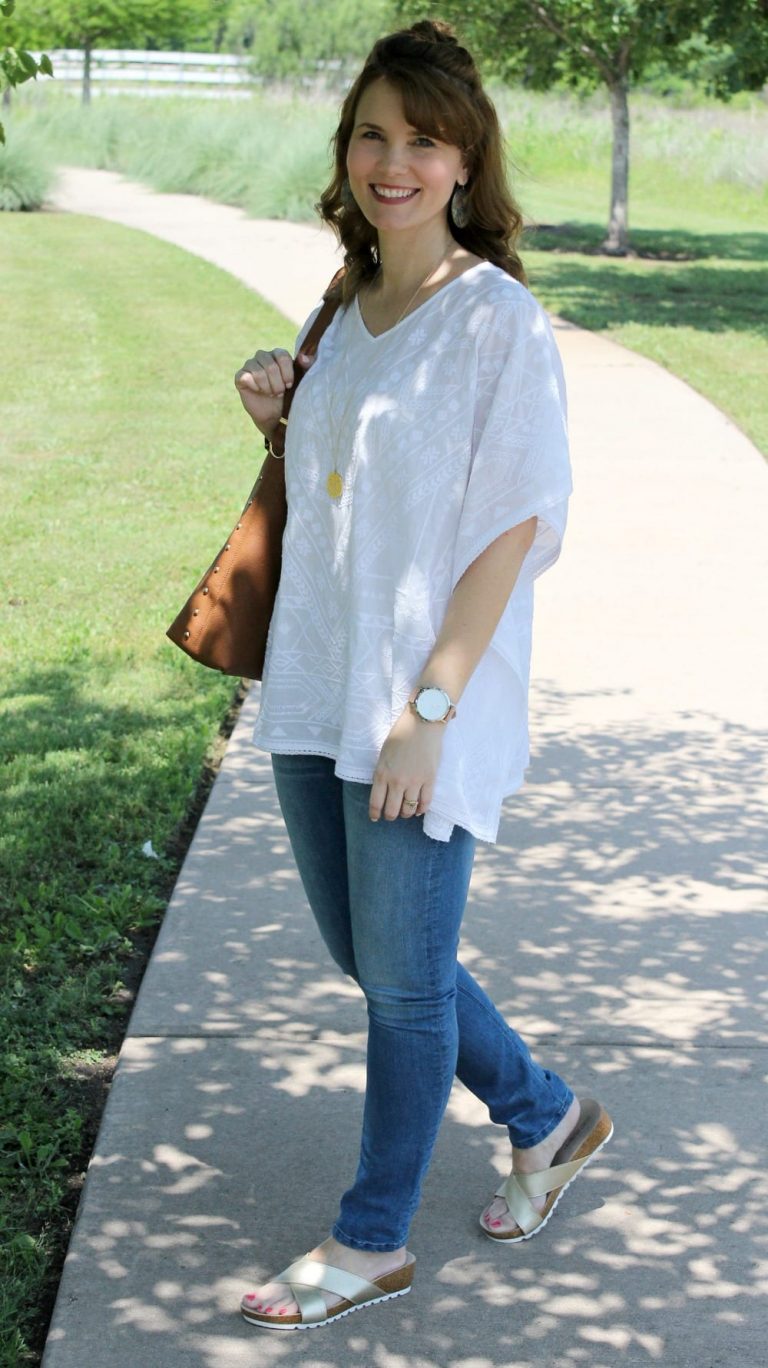 Casual spring outfit idea - White embroidered poncho, light denim, gold sandals from Secret Celebrity and a brown tassel handbag.