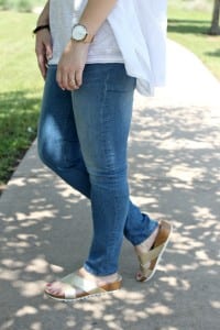 Casual spring outfit idea - White embroidered poncho, light denim, gold sandals from Secret Celebrity and a brown tassel handbag.