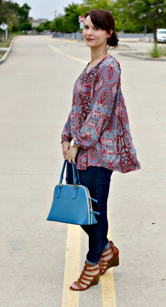 Women's Fall Outfit Ideas featuring a paisley print blouse, blue handbag and wedges.