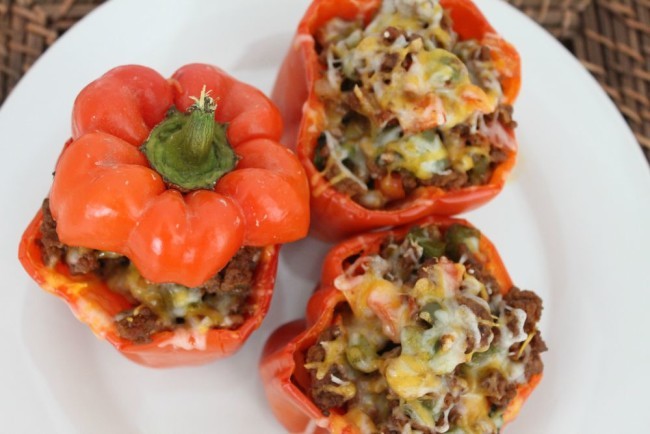 This easy stuffed bell peppers recipe is perfect for a weeknight meal. You won't believe how great it makes your house smell! Plus it's kid pleasing. This takes 50 minutes to prepare from chopping the veggies, to pulling it out of the oven. To make it a little faster, prepare your veggies before you leave for work in the morning. I used ground beef, but you could easily swap out turkey or make it vegetarian with quinoa. 