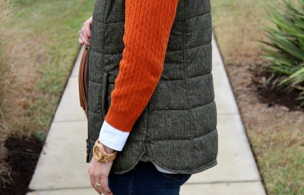 Dressing for fall and winter is all about layering. This fall outfit idea not only features the colors of season, but also features layers I love. Pair a crisp white button up with a cable knit sweater, quilted vest, your favorite skinny jeans and riding boots.