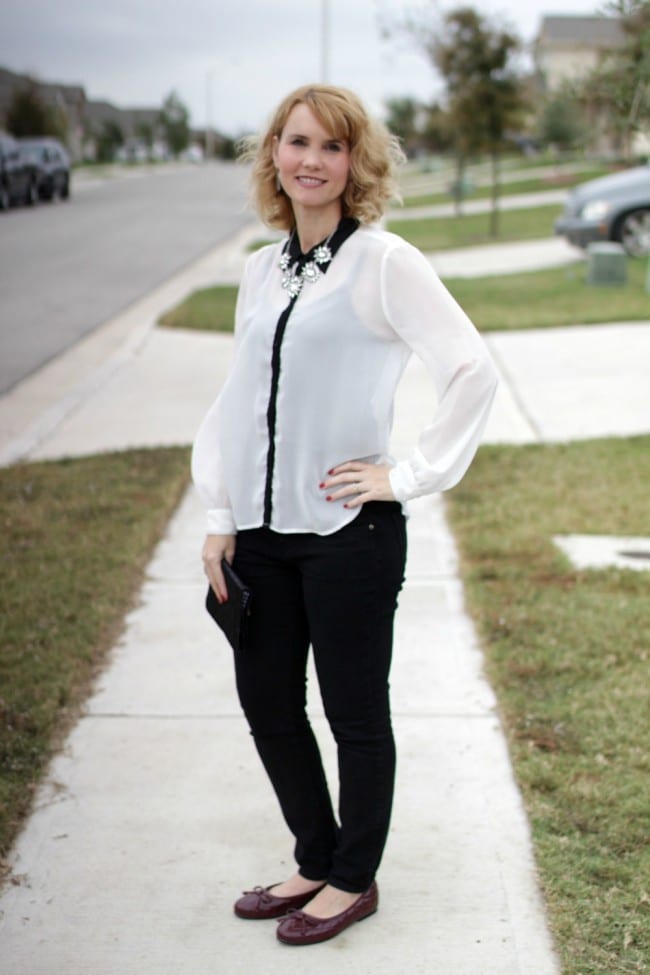 Black and white outfit idea - I styled a pair of black jeans with a white and black long sleeve shirt, burgundy bow flats and a statement necklace.