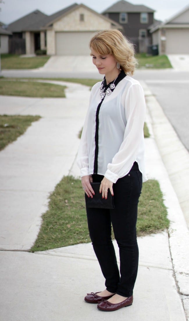 Black and white outfit idea - I styled a pair of black jeans with a white and black long sleeve shirt, burgundy bow flats and a statement necklace.