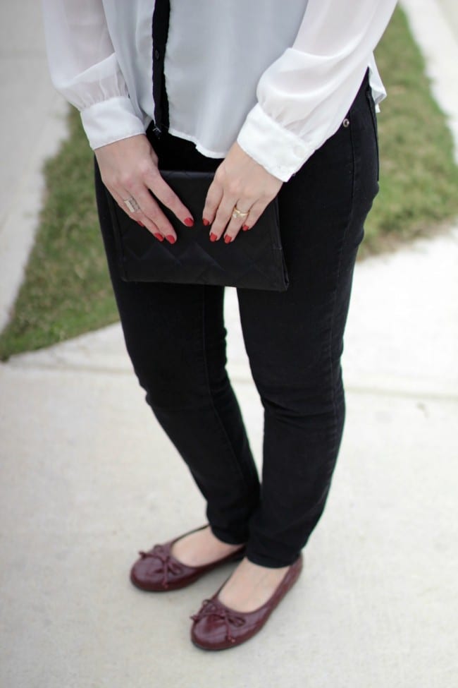 Black and white outfit idea - I styled a pair of black jeans with a white and black long sleeve shirt, burgundy bow flats and a statement necklace.