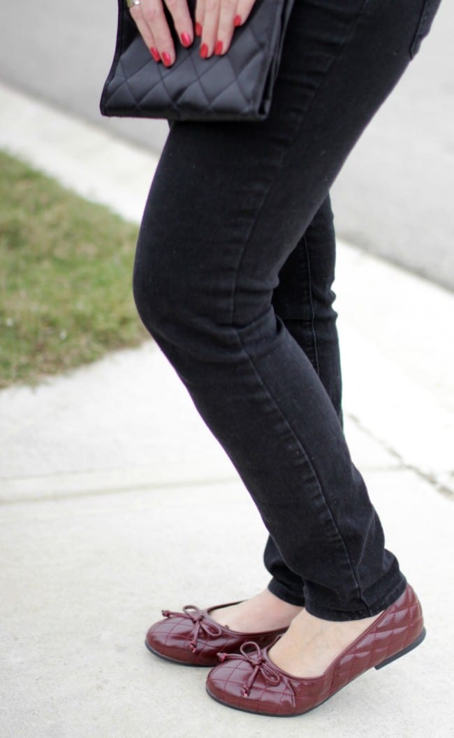 Black and white outfit idea - I styled a pair of black jeans with a white and black long sleeve shirt, burgundy bow flats and a statement necklace.