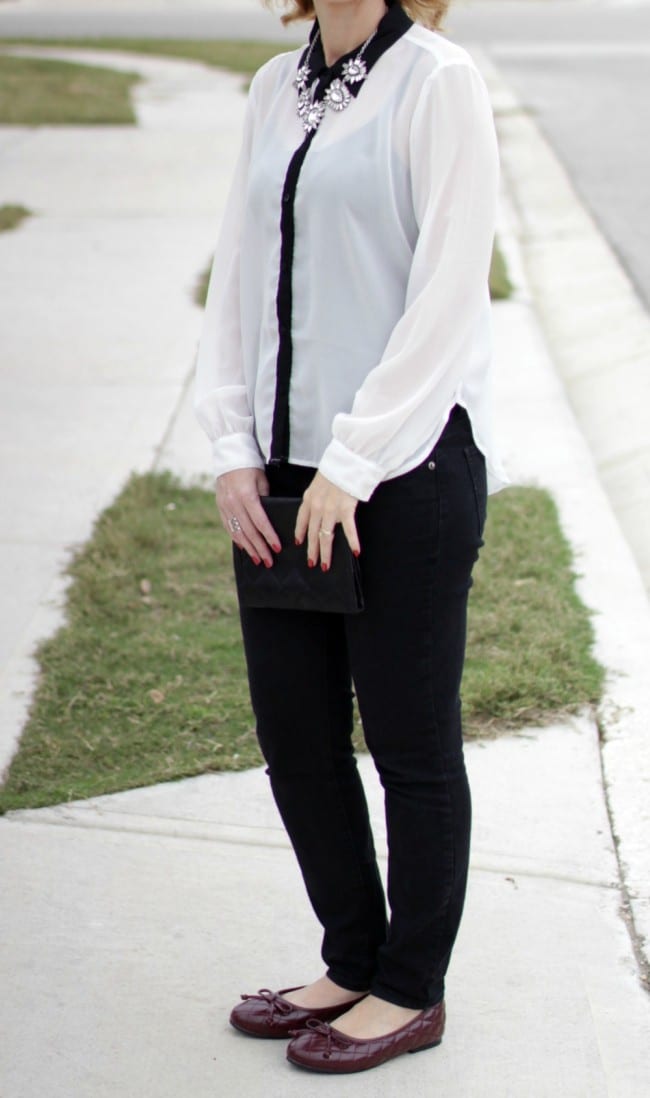 Black and white outfit idea - I styled a pair of black jeans with a white and black long sleeve shirt, burgundy bow flats and a statement necklace.