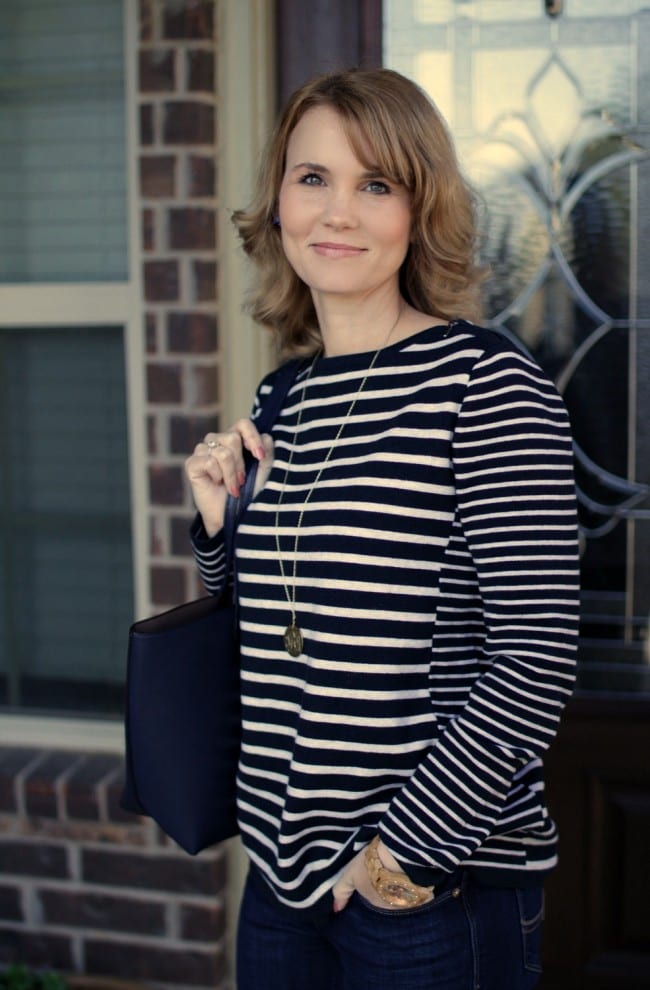 Casual Outfit idea - pair a striped shoulder-zipped pullover with your favorite jeans and riding boots.