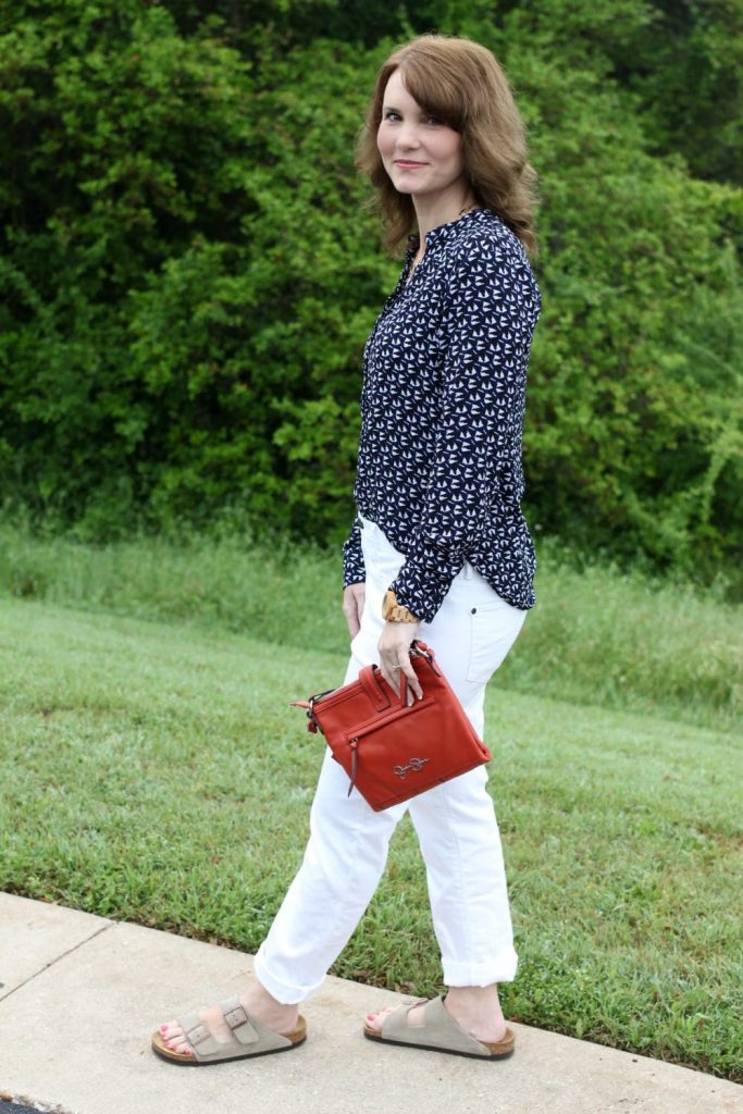 Spring fashion: White boyfriend jeans, Birkenstocks, button up shirt, orange handbag.