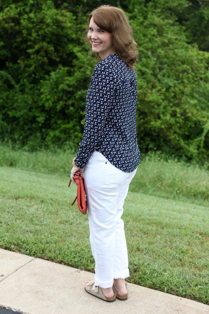 Spring fashion: White boyfriend jeans, Birkenstocks, button up shirt, orange handbag.