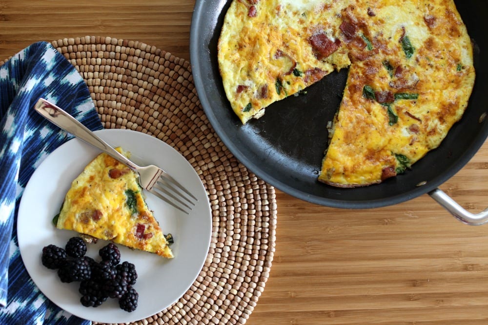 Looking for frittata recipes? This Bacon and Spinach Frittata is perfect for breakfast, lunch or dinner. With ingredients like bacon, fresh spinach and onion, it's full of flavor and a complete meal. Just add some fresh fruit and you're good to go!