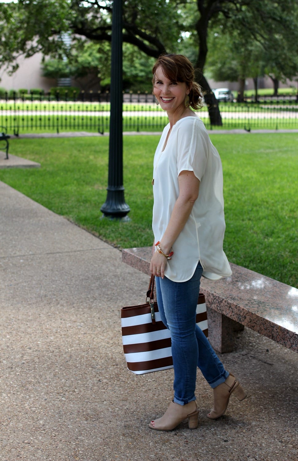 I love tunic tops and they make putting together an outfit I feel good in so easy. This classic tunic from J. Jill is paired with light denim, nude peep toe booties and a striped tote bag.