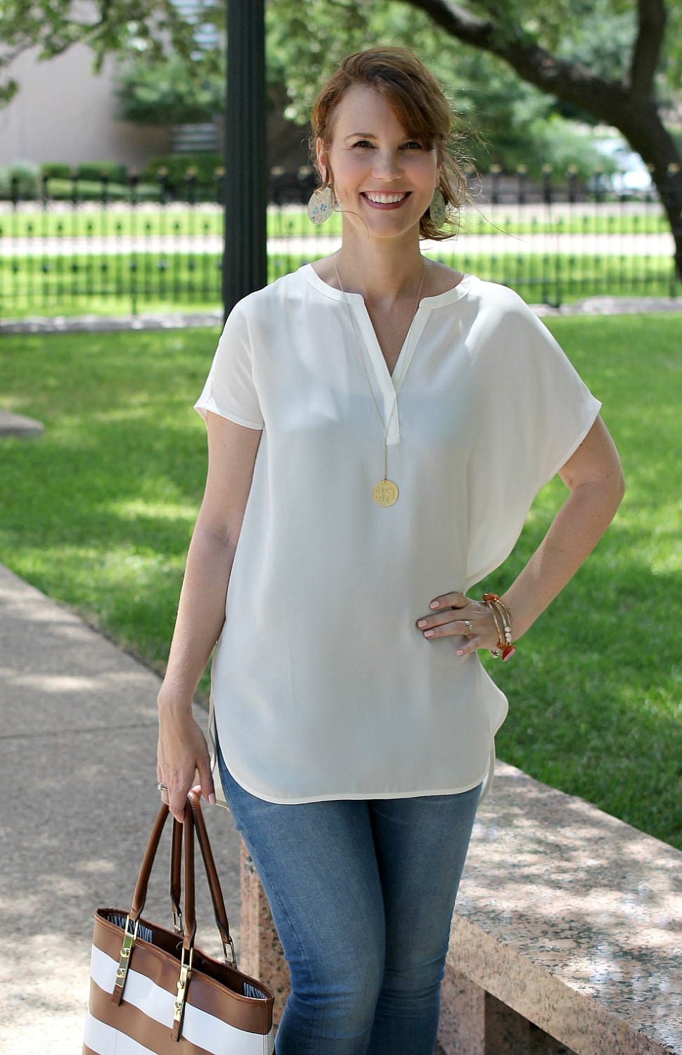 I love tunic tops and they make putting together an outfit I feel good in so easy. This classic tunic from J. Jill is paired with light denim, nude peep toe booties and a striped tote bag.