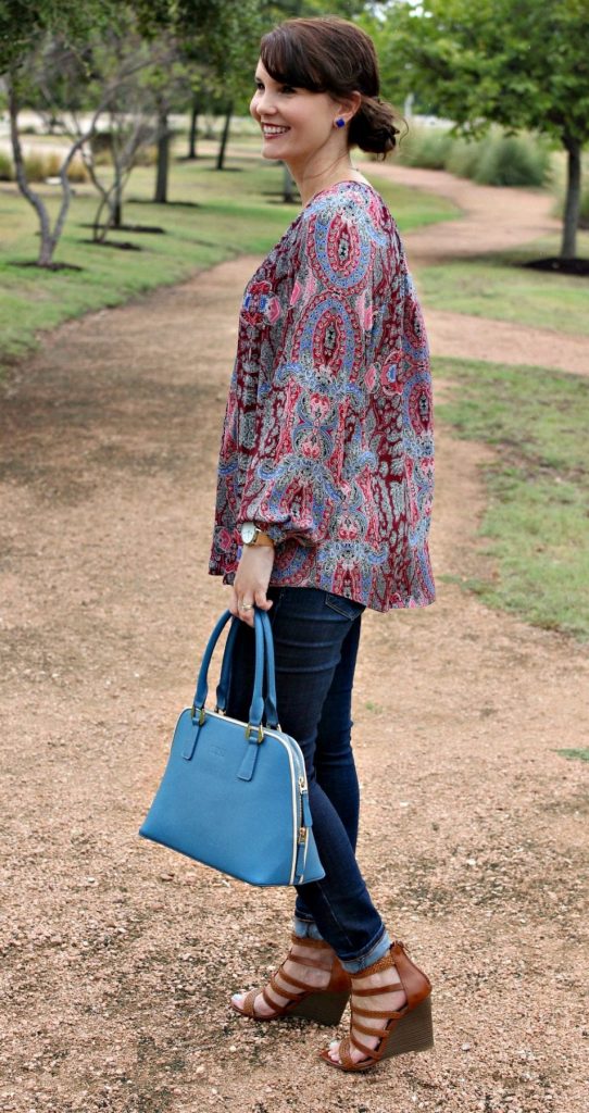 Women's Fall Outfit Ideas featuring a paisley print blouse, blue handbag and wedges.