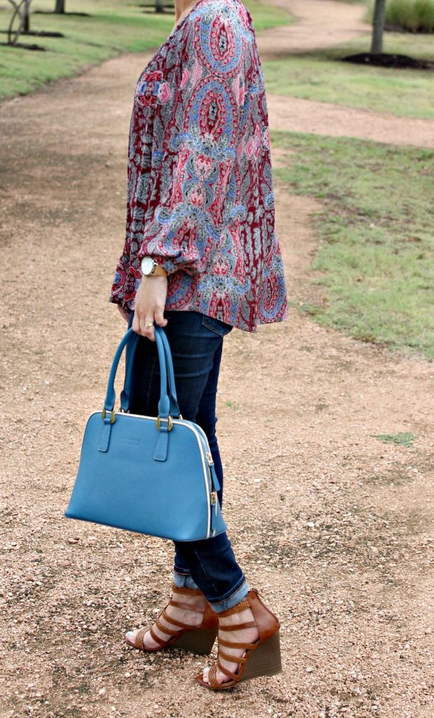 Women's Fall Outfit Ideas featuring a paisley print blouse, blue handbag and wedges.