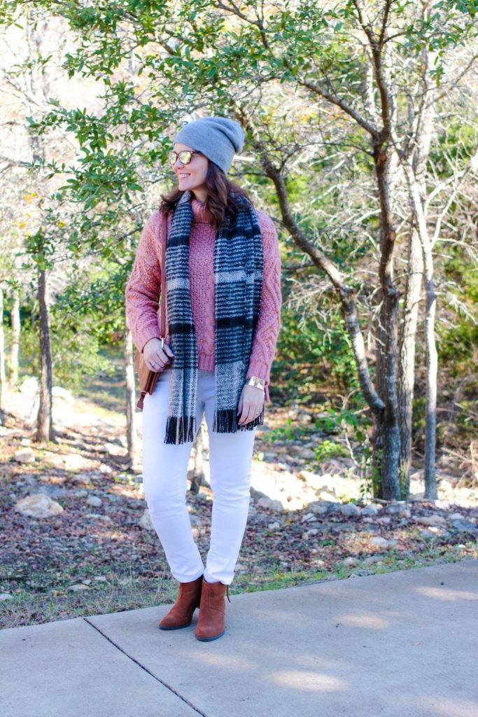 White jeans outfit winter edition: mauve sweater, white denim, brown ankle boots.