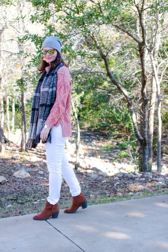White jeans outfit winter edition: mauve sweater, white denim, brown ankle boots.