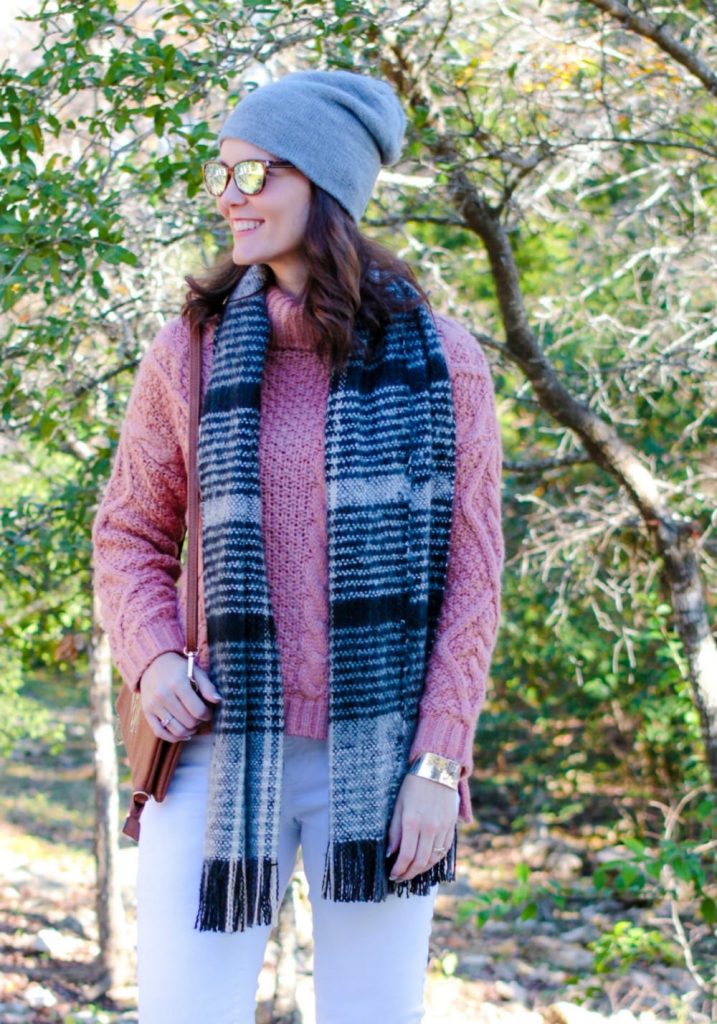 White jeans outfit winter edition: mauve sweater, white denim, brown ankle boots.