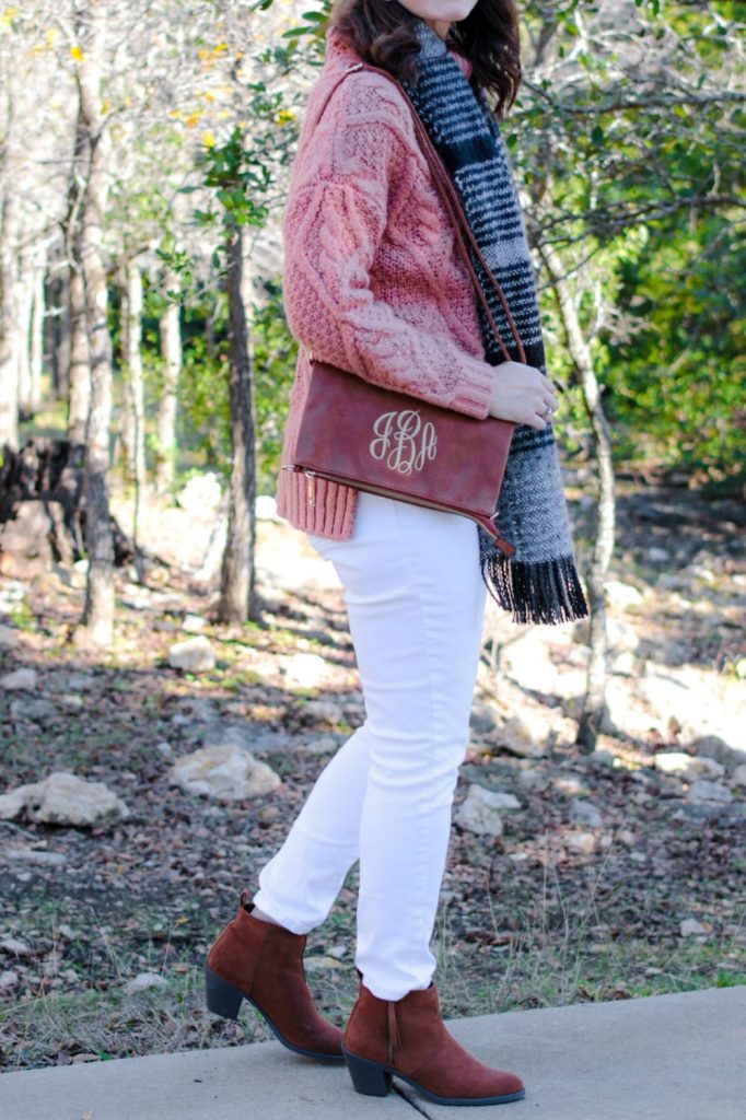 White jeans outfit winter edition: mauve sweater, white denim, brown ankle boots.