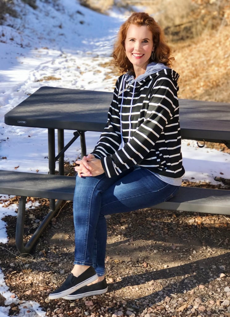 Casual weekend outfit - black and white striped sweatshirt, jeans and slip-on sneakers.