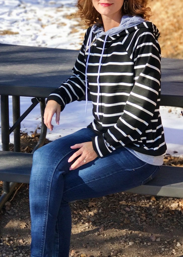 Casual weekend outfit - black and white striped sweatshirt, jeans and slip-on sneakers.