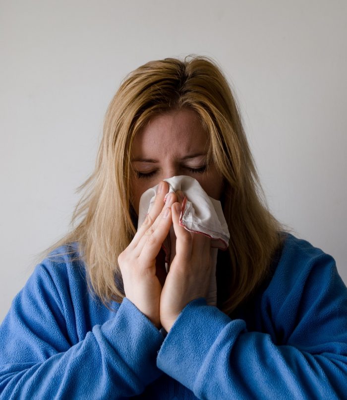 woman sneezing