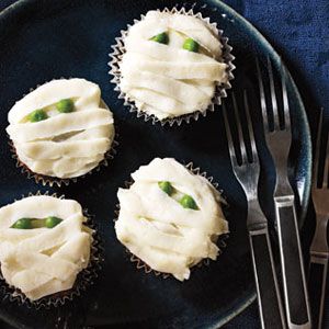 Cupcake sized meatloaves with mashed potatoes piped on top to look like a mummy, complete with two peas for eyes.